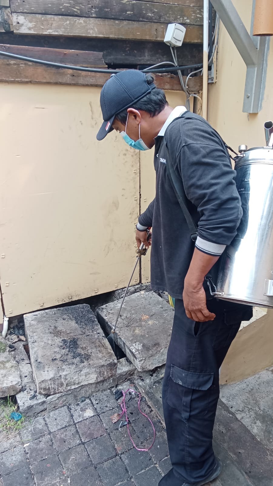 Termokil technician treating drains and entry points against pests