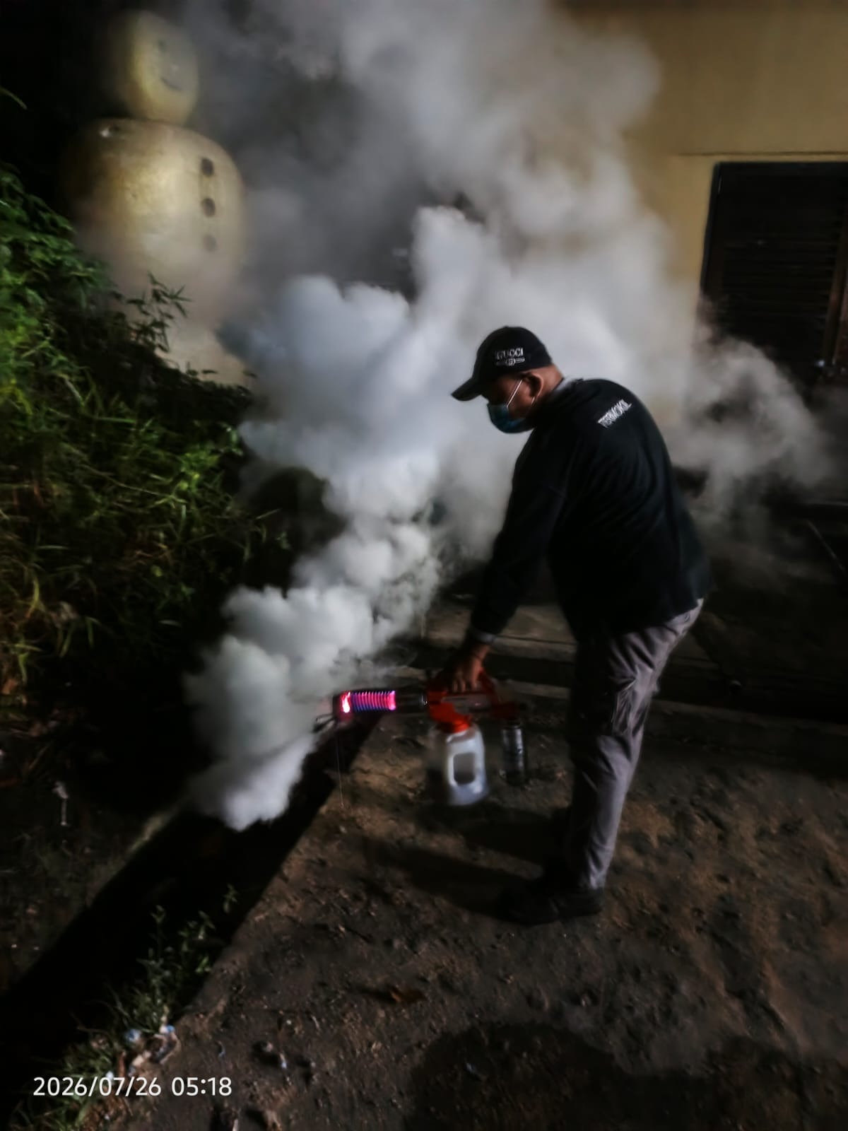 Termokil technician performing night thermal fogging fumigation